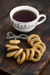 Bagels with cup of tea on a wooden board.