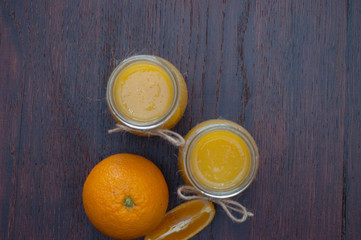 Orange and juice in two jars, rustic style top view, copy space, flat lay