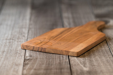Empty cutting board on weathered wood