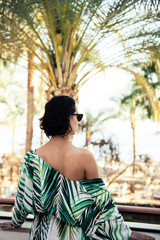 woman looking forward in tropical beach