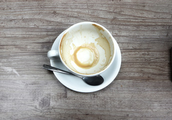 Empty coffee cup on a grunge wooden table