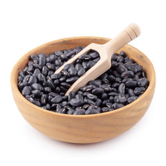 Black bean in a wooden bowl isolated on white background