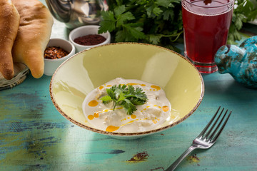 stew chicken in a creamy sauce with parsley on blue wooden table