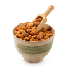 Almonds in wooden bowl isolated on a white background