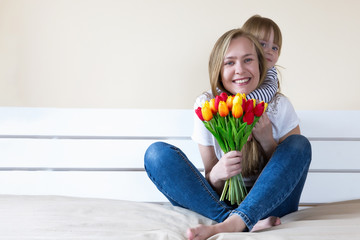 Mother and daughter holding tulip flowers