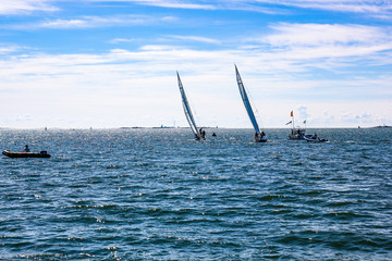 Two white boats in the water on a cloudy sunny day, summer. Sea view, sail. Helsinki, Finland.