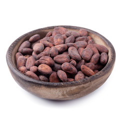 Cocoa fruit in a wooden bowl, raw cacao beans isolated on a white background