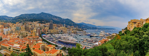 Monte Carlo panorama with luxury yachts and grand stands by the in harbor for Grand Prix F1 race in...