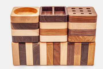 Assortment of wood handcraft pieces in row on white background