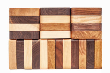Assortment of wood handcraft pieces in row on white background
