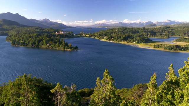 Wind blowing and causing waves on the surface of Nahuel Huapi Lake located near Bariloche city, Patagonia, Argentina. Southern Andes mountains are spread across the horizon. Shot from Punto Panoramico