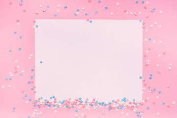 Little stars confetti on pink background. Holyday concept. Copy cpase for your text.