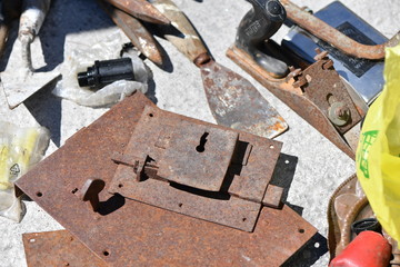 Old tools and a rusty door lock on a flea market in Spain.