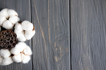 Background for a banner with brown lace and natural cotton flowers on a wooden background. Banner design for greeting card. Background for women's blog. Flat lay, top view.