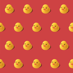 repeatable pattern of yellow rubber duck on red background Modern style. creative photography.