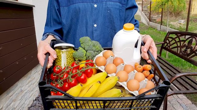 Woman Carrying Box With Groceries After Home Delivery