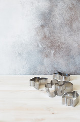 Set of cookies cutters on a white wooden background