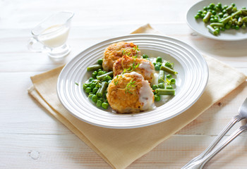Fish cutlets with green peas and beans