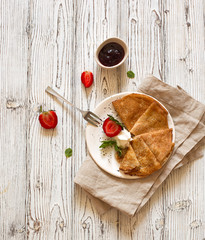 Pancakes with fresh strawberries and jam