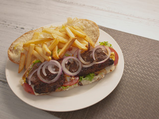 Long Smokey Meat Steak Sandwich with Onions Cheese and French Fries 