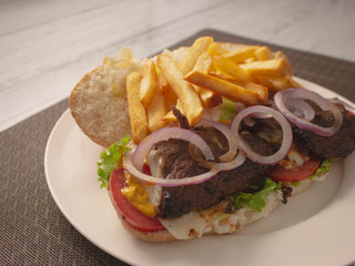 Long Smokey Meat Steak Sandwich with Onions Cheese and French Fries 