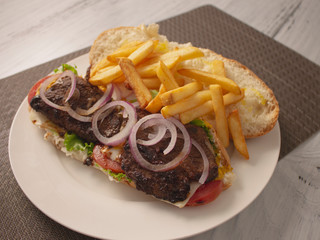 Long Smokey Meat Steak Sandwich with Onions Cheese and French Fries 