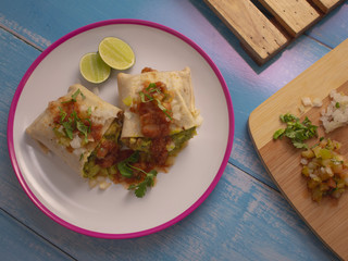 Soft Tortilla Chicken Burrito with Avocado and Spicy Tomato Sauce and a touch of Lime 