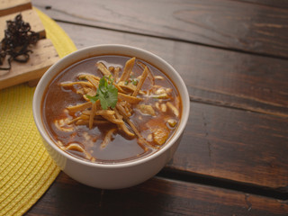 Bowl of Tortilla Soup with Cream Cheese Avocado and Cilantro Tomato and Onions 