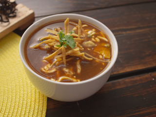 Bowl of Tortilla Soup with Cream Cheese Avocado and Cilantro Tomato and Onions 