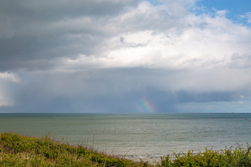 Looking out to sea near Eastbourne in Sussex, with part of a rainbow on the horizon
