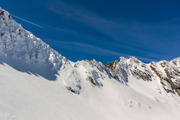Fototapeta na wymiar winter landscape with the mountain peaks covered by heavy snow. aerial view by drone. romanian mountains, Negoiu peak, Fagaras Mountains