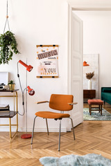 Stylish compositon of retro home interior with mock up poster frame, vintage orange chair, velvet sofa, design lamps, gold shelf, plants and elegant accessories. Nice home decor of living rooms. 