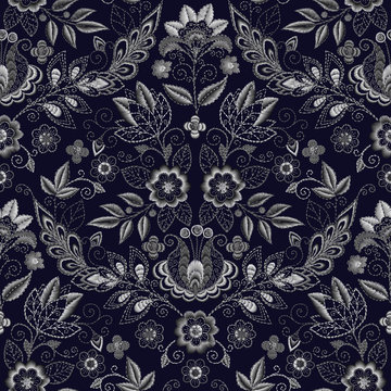 Embroidery seamless pattern with beautiful flowers. Vector handmade floral ornament on dark background. Embroidery for fashion products. Elegant tiled design, best for print fabric or papper and more.