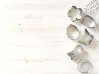 Set of cookies cutters on a white wooden background