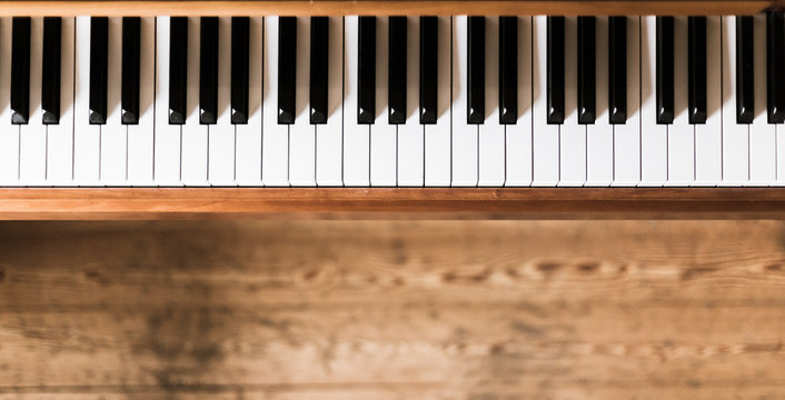 Vintage wooden piano keys, wooden blurry floor