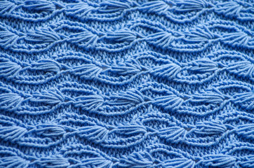The texture of a knitted woolen fabric blue.