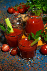 fresh tomato juice in glass cups, closeup top view
