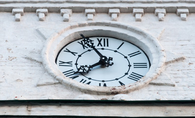 Fototapeta na wymiar clock face from the clock tower. the hands of time. white dial. black arrows and black numbers. time.
