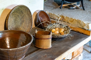Kitchen utensils in the interior of old traditional rural wooden house.