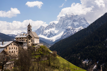 Beautiful mountain scenery in the Alps with fresh green meadows in bloom on a beautiful sunny day in springtime. Dolomiti montains in Italy. Landscape in spring in Europe. 