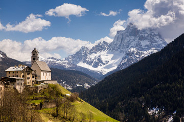 Fototapeta na wymiar Beautiful mountain scenery in the Alps with fresh green meadows in bloom on a beautiful sunny day in springtime. Dolomiti montains in Italy. Landscape in spring in Europe. 