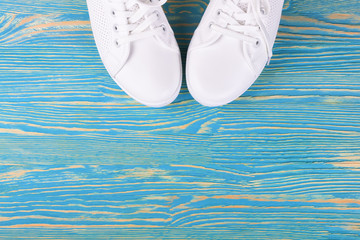 white sneakers on color background. copy space.