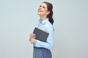 happy young woman with toothy smile holding book.