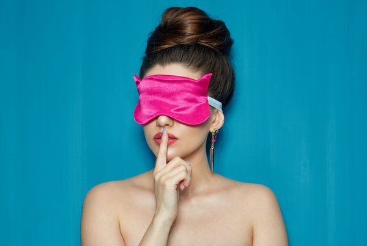 Young Woman Wearing Pink Sleeping Mask Touching Lips