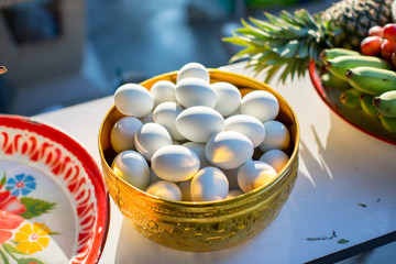 Elegant golden bowl for bride and groom give aims food to Buddhist monk in thai traditional wedding ceremony