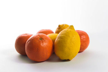 Tangerines and lemons on white background.