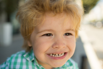 Milk teeth. Childrens dentist. The boy shows his teeth close-up. Baby smile. Portrait of a boy.