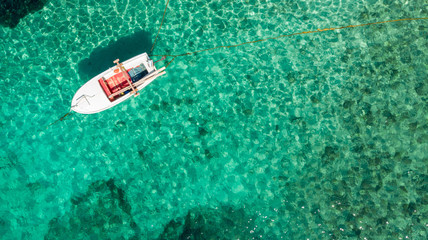 Fototapeta premium Drop down view of fishing boats anchored in bay.