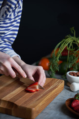 Woman cutting strawberries