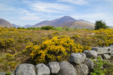 A landscape image of the Mountains of Mourne on an, unusually, sunny bright day.  The image depicts clearly the rugged terrain which characterises this part of Northern Ireland&rsquo;s south east coast. 